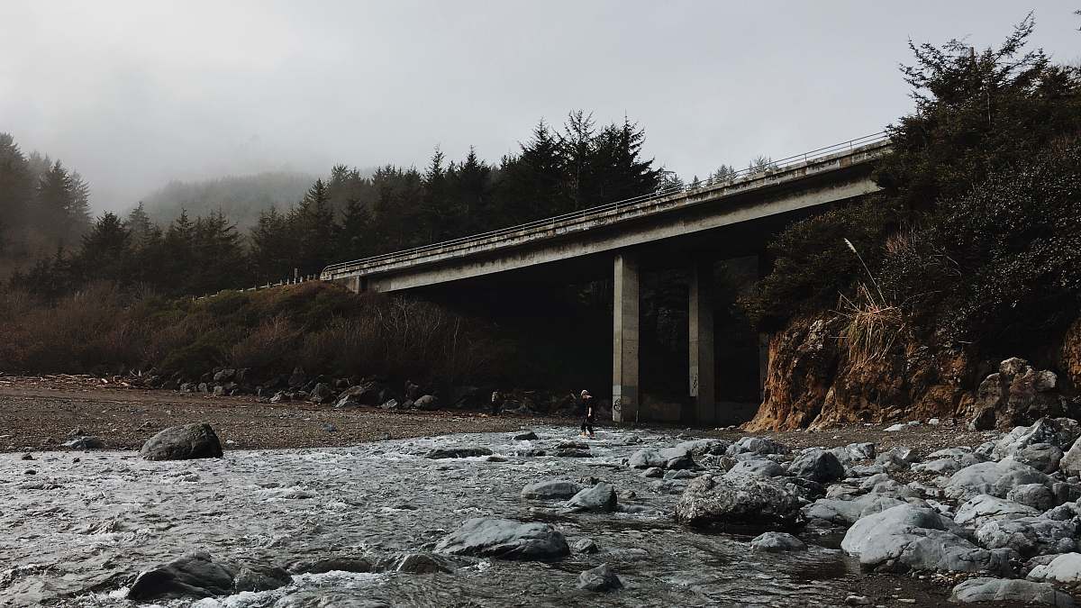 california gray concrete bridge near trees at daytime klamath